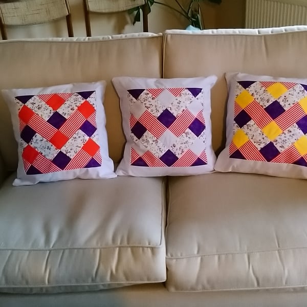 Patchwork cushion covers in red, yellow and purple. Three  available. 
