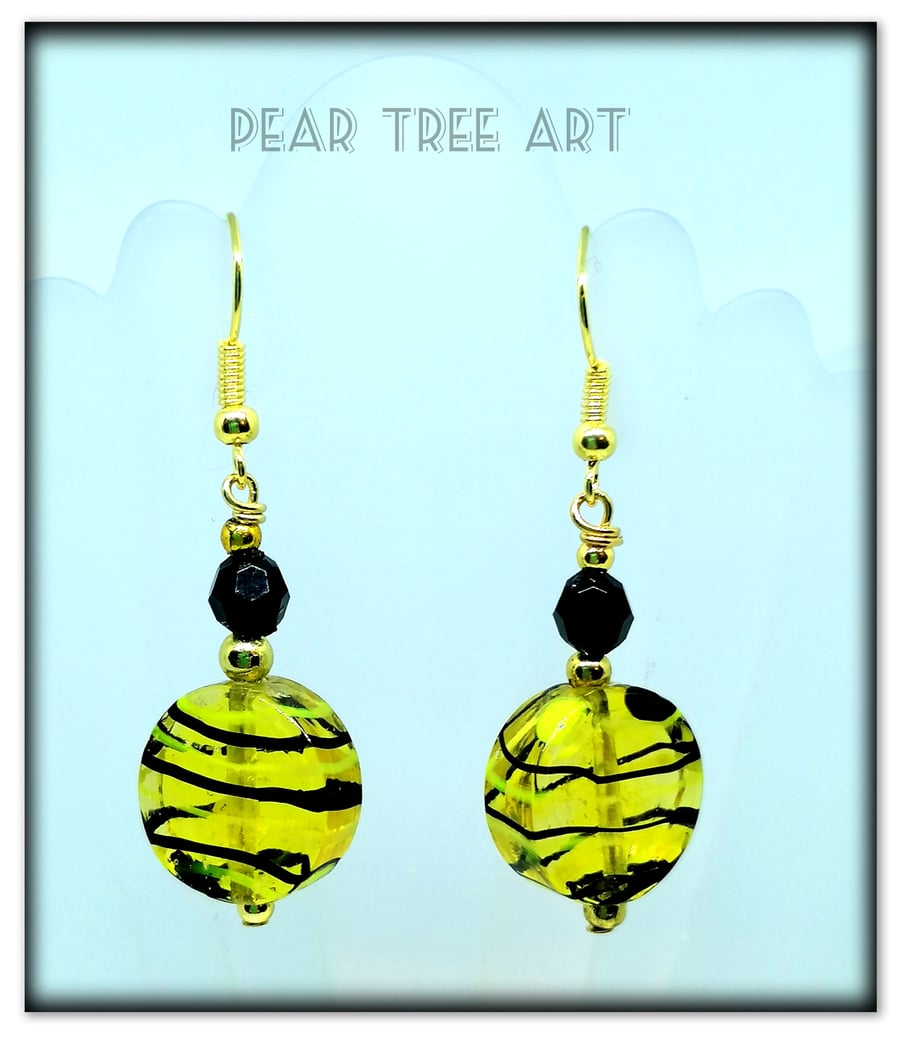 Yellow and black glass beads earrings on gold plated hooks.