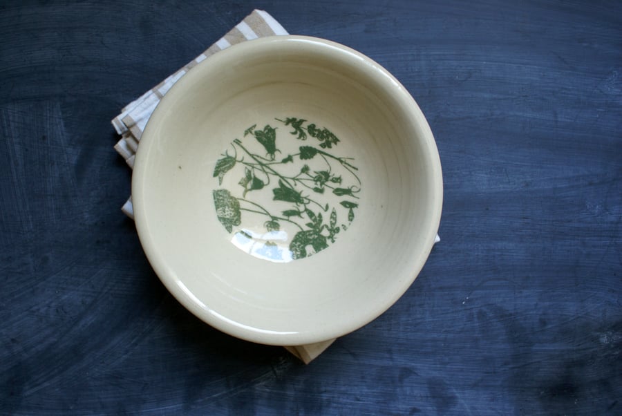 Handmade shallow ceramic bowl with green floral design