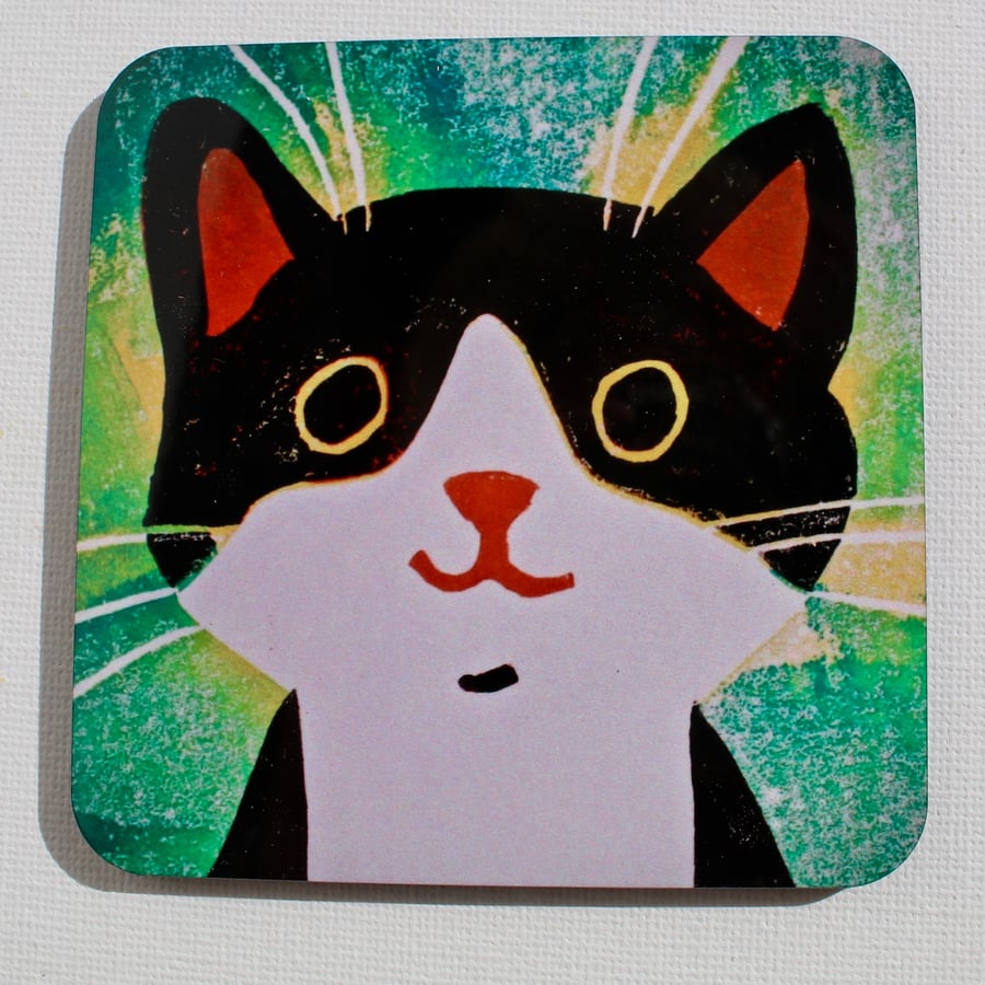 BLACK AND WHITE CAT ON GREEN COASTER 