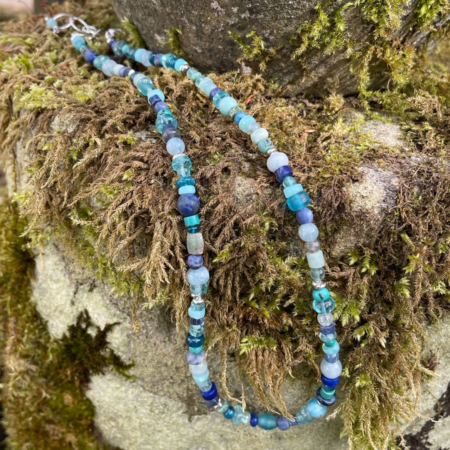 Gemstone and sterling silver bead necklace in blues.