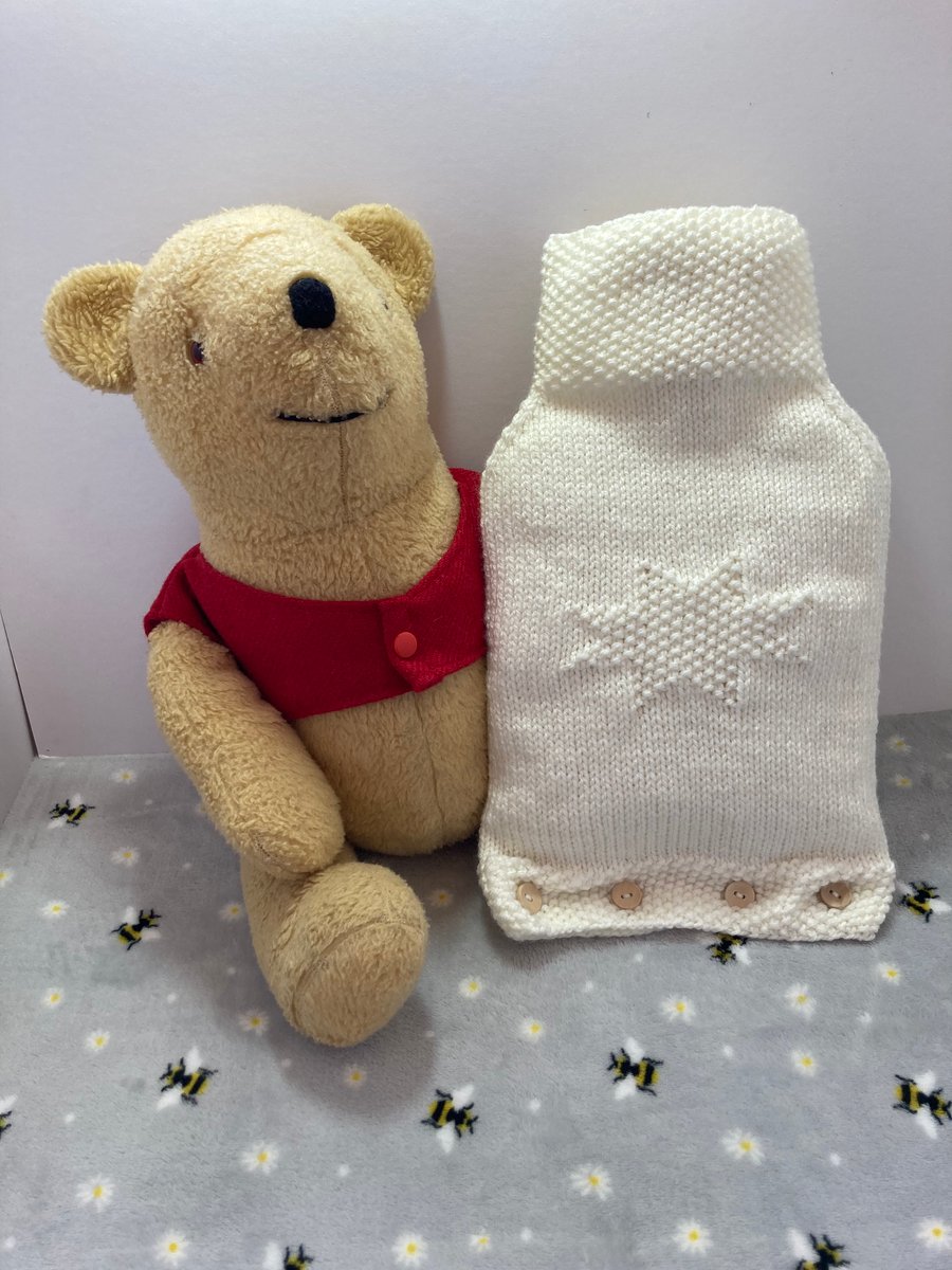 Knitted hot water bottle cover in cream 