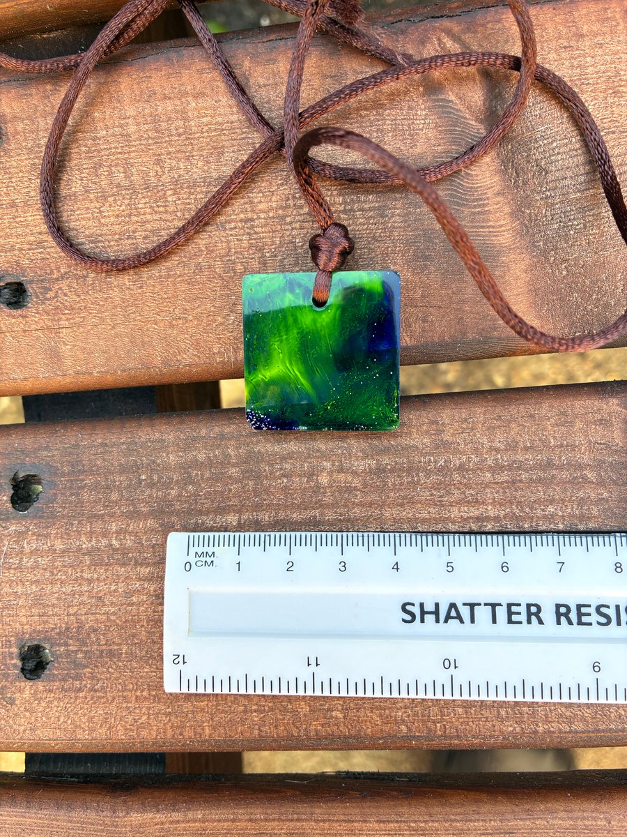 Square resin seascape pendant on soft brown cord