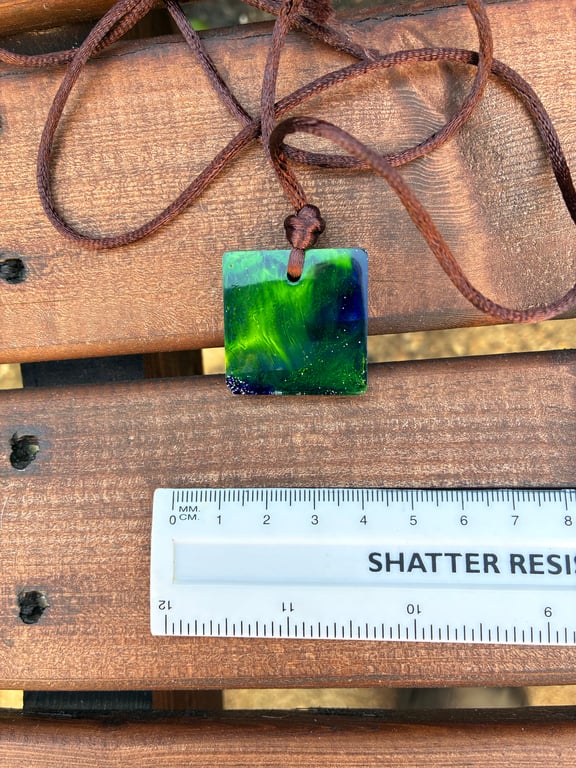 Square resin seascape pendant on soft brown cord