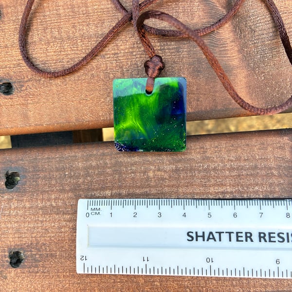 Square resin seascape pendant on soft brown cord