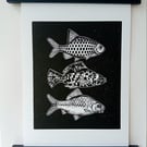 Linocut print of Three Little Fish handprinted in black
