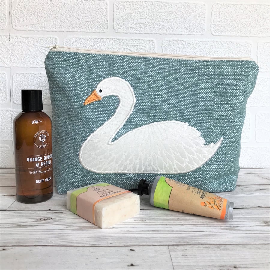 Turquoise toiletry bag with white applique swan