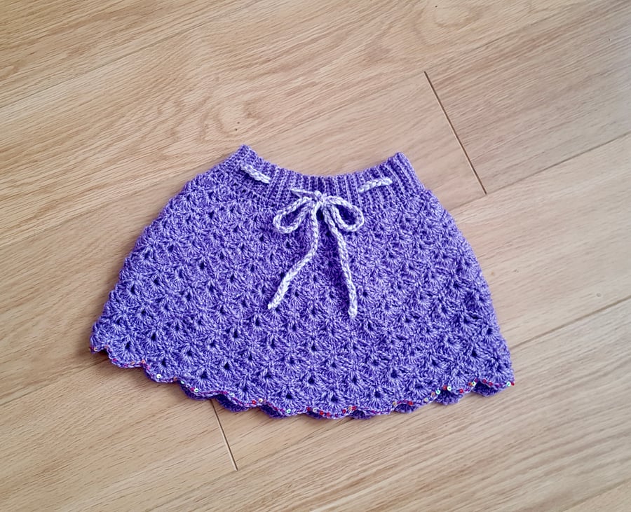 Handmade crochet lavender skirt with sequins at base of skirt. Waist 16”.
