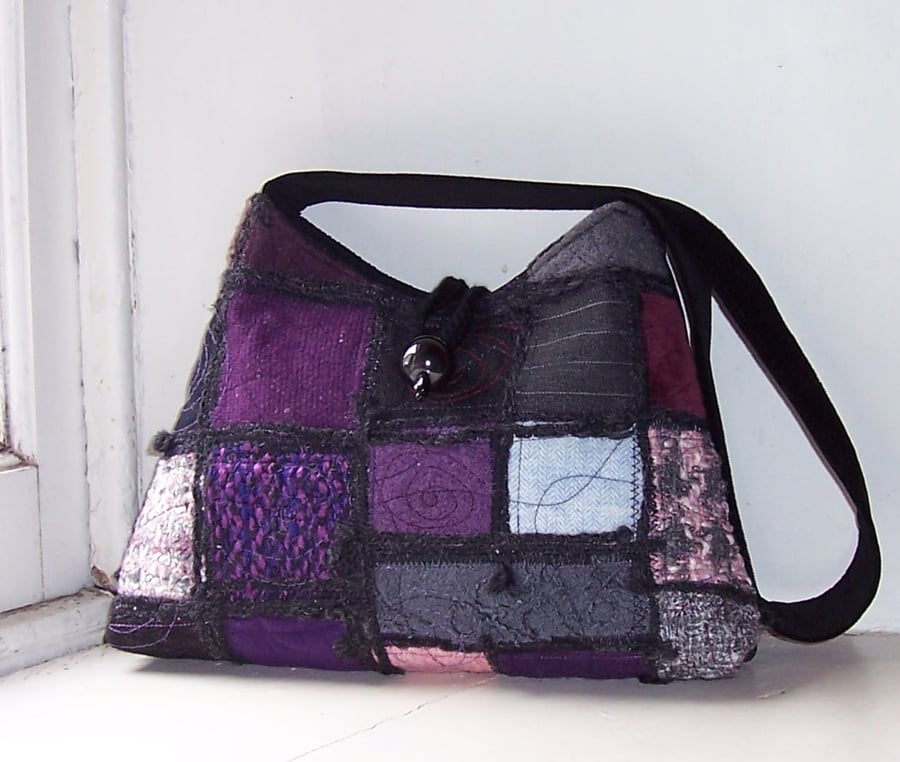 Textile art shoulder bag in purple, black and pink patchwork