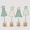A Christmas Tree with a Wire Stem and Wooden Block Stand