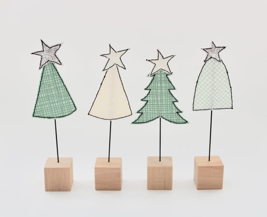 A Christmas Tree with a Wire Stem and Wooden Block Stand