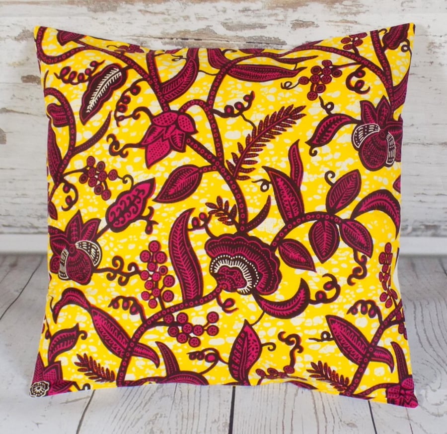 Cushion cover. African wax print, magenta and burgundy on yellow