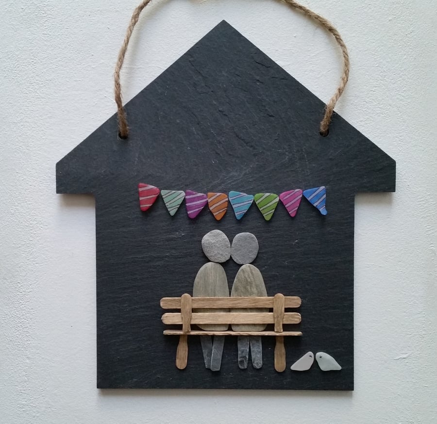 Hanging Slate House with a Pebble Couple on a Wooden Bench.