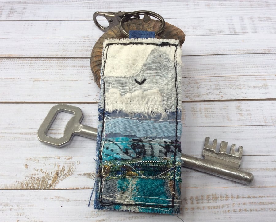 Embroidered upcycled seascape key ring or bag charm. 