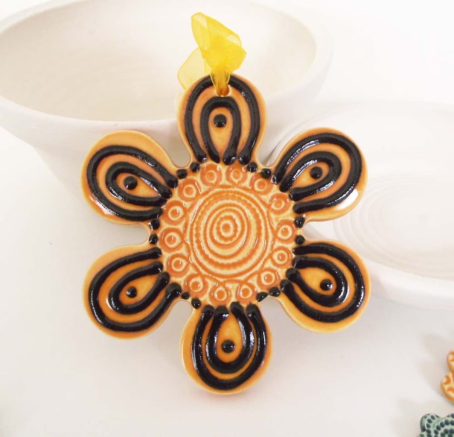 Orange ceramic flower decoration.