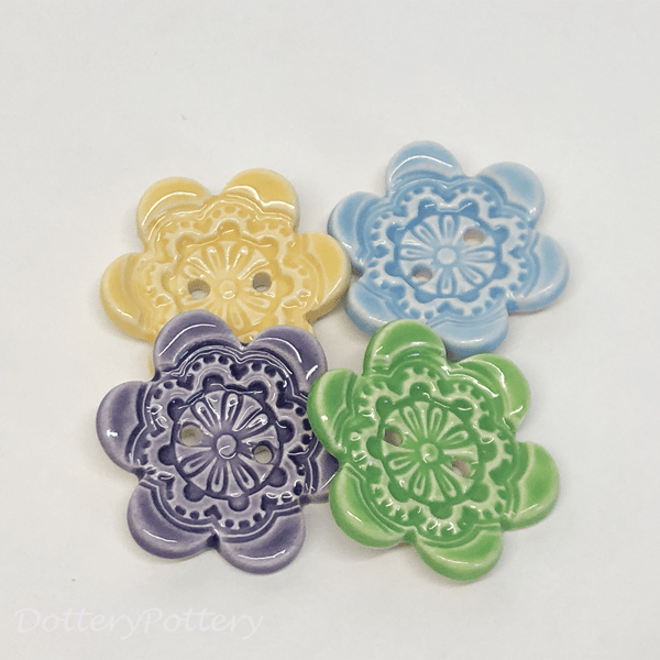 Set of four flower shaped ceramic handmade buttons