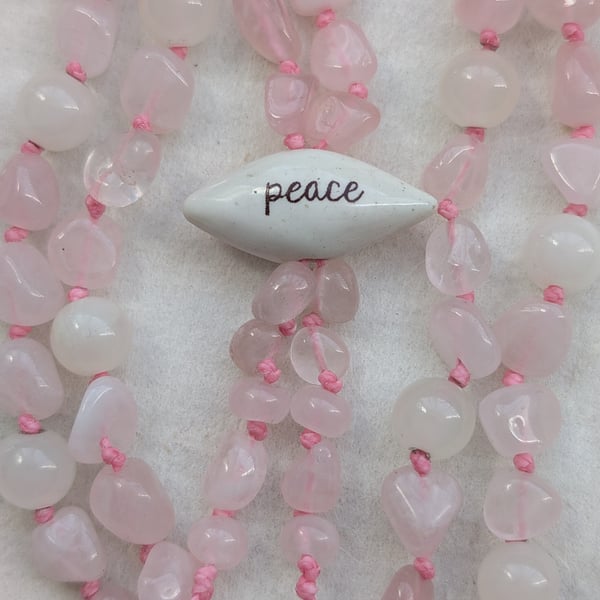 Rose quartz and jade knotted cord necklace with peace ceramic focal bead