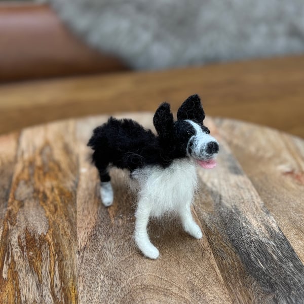 Small black and white standing border collie, sheep felt dog