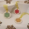 Set of three little bright snowflakes handmade ceramic decorations