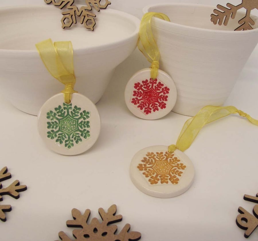 Set of three little bright snowflakes handmade ceramic decorations