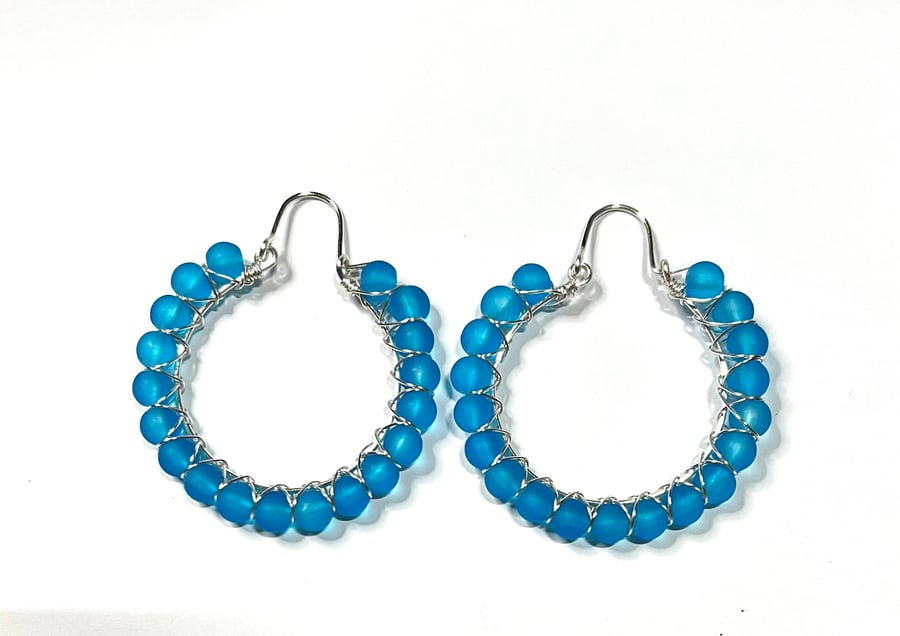Silver plated hoop earrings with blue frosted glass beads 