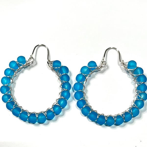 Silver plated hoop earrings with blue frosted glass beads 