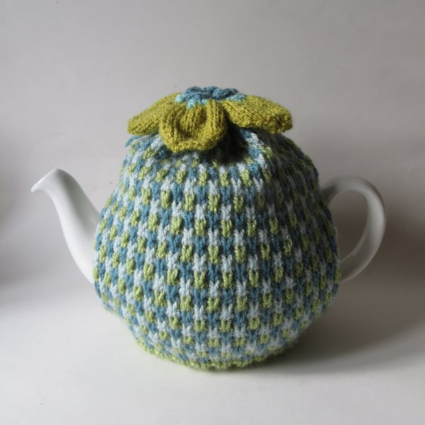 Tea cosie Tea cosy - green tweed with anemone flower