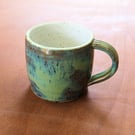 Stoneware pottery mug finished in a muli-colour green glaze