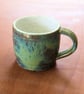Stoneware pottery mug finished in a muli-colour green glaze - Image 1