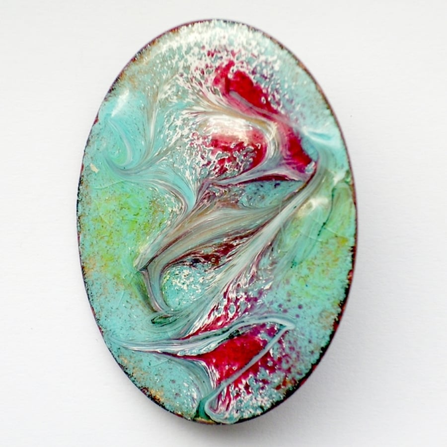 enamel brooch - scrolled red, green and white over turquoise