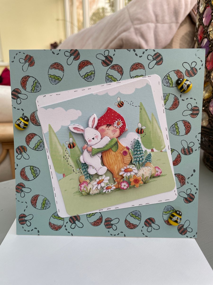 Cute little boy cuddling a rabbit birthday or Easter card