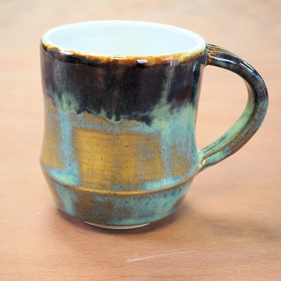  Stoneware pottery mug finished in a turquoise, blue and brown multicolour glaze