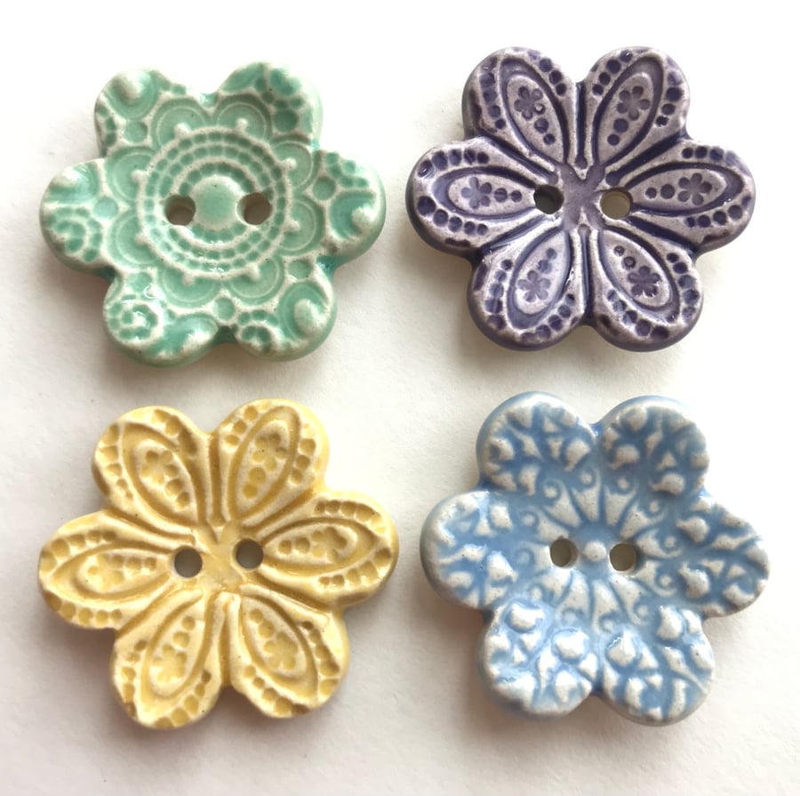 Set of four flower shaped ceramic handmade buttons