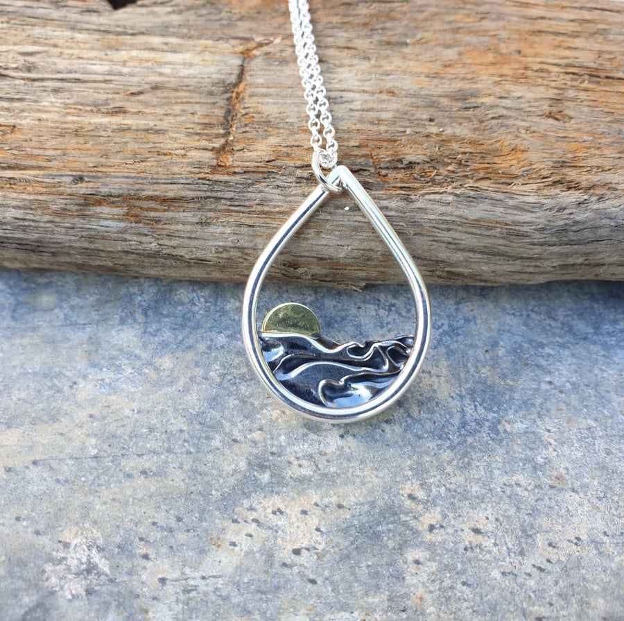 Silver sun rising over the sea mountains hills pendant