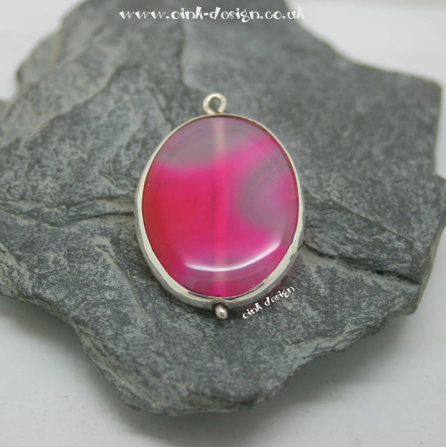 A slice of pink agate set in sterling silver