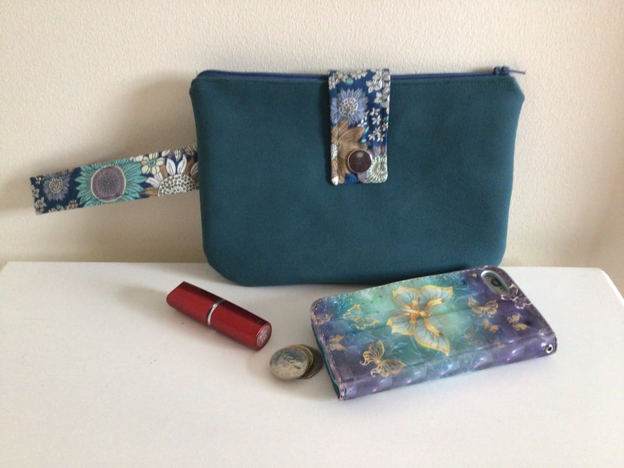 Teal faux suede clutch bag. With floral accents.