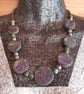 Disc shaped necklace in dark green and magenta - Image 1