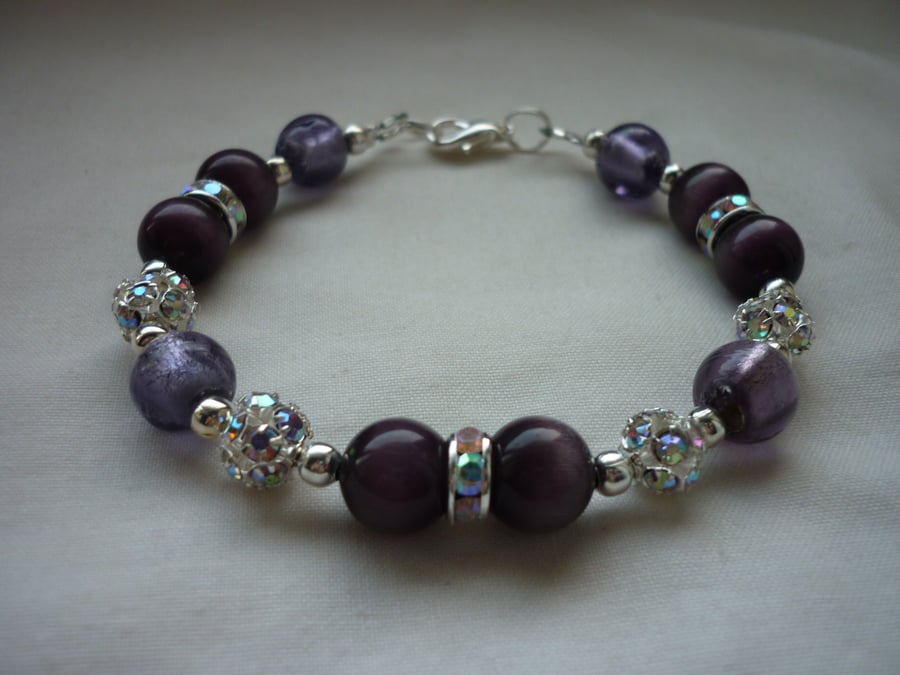 DARK VIOLET AND SILVER LINED PURPLE RHISNESTONE BRACELET.  659