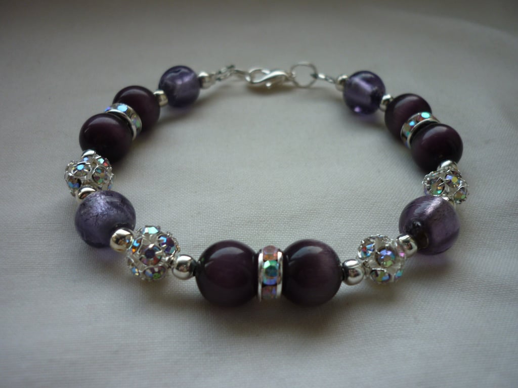 DARK VIOLET AND SILVER LINED PURPLE RHISNESTONE BRACELET.  659