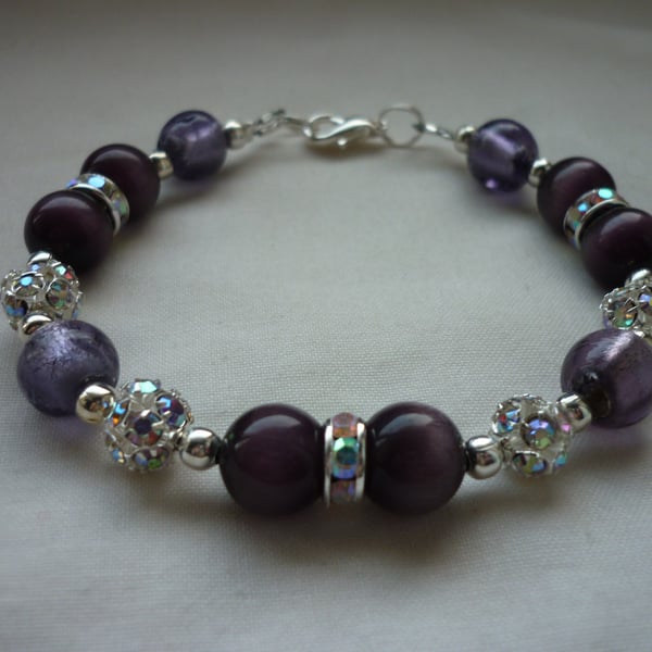 DARK VIOLET AND SILVER LINED PURPLE RHISNESTONE BRACELET.  659