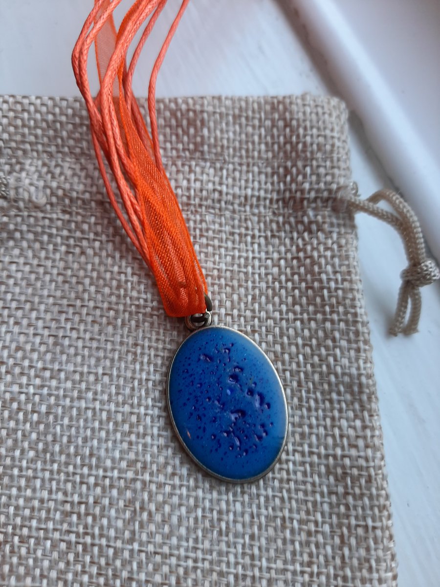 Deep Blue Circle resin pendent with a orange organza ribbon necklace