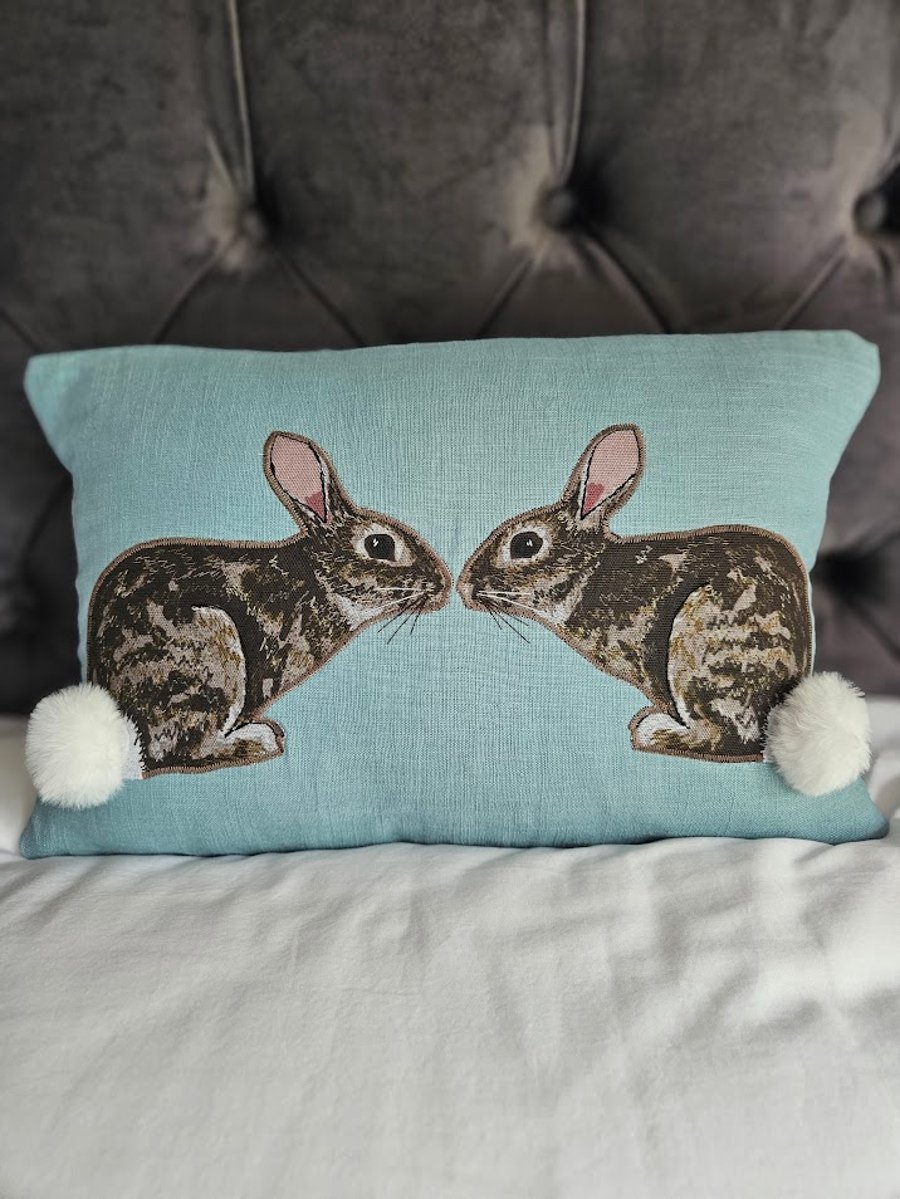 Handmade linen cushion with applique printed rabbit design & fluffy pompom tails