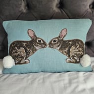 Handmade linen cushion with applique printed rabbit design & fluffy pompom tails