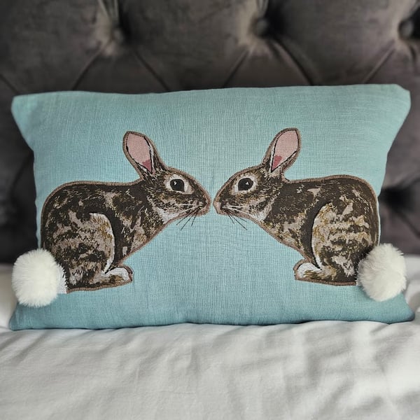 Handmade linen cushion with applique printed rabbit design & fluffy pompom tails