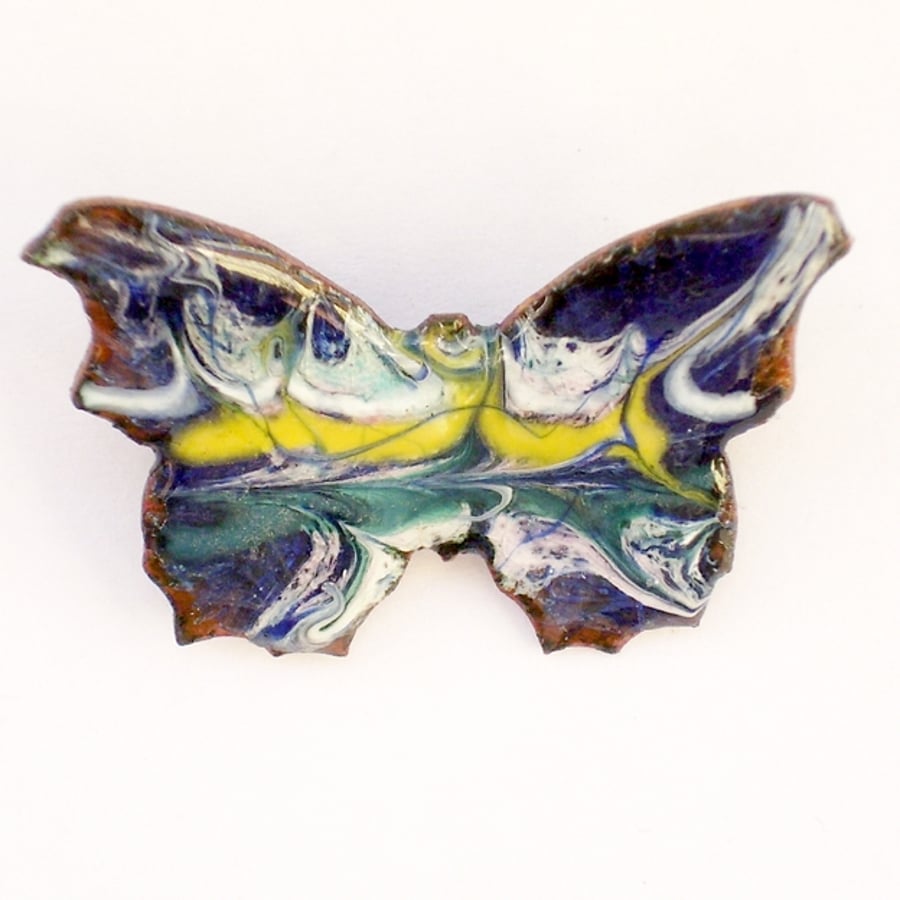 enamel brooch - butterfly scrolled white, yellow and green on dark blue