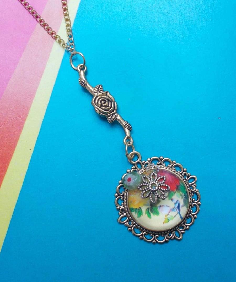 A Glass Cabochon Pendant with Japanese Floral Imagery and Embellishments