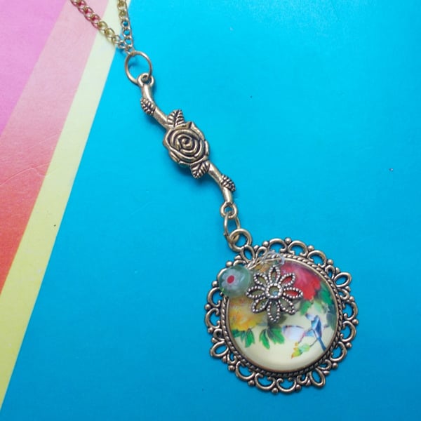 A Glass Cabochon Pendant with Japanese Floral Imagery and Embellishments