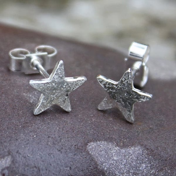 Tiny silver star stud earrings.