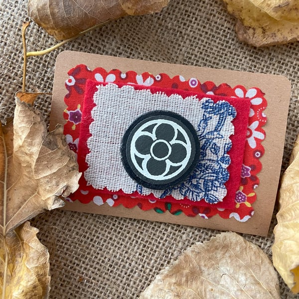 Medieval style wooden brooch with black quadrafoil pattern