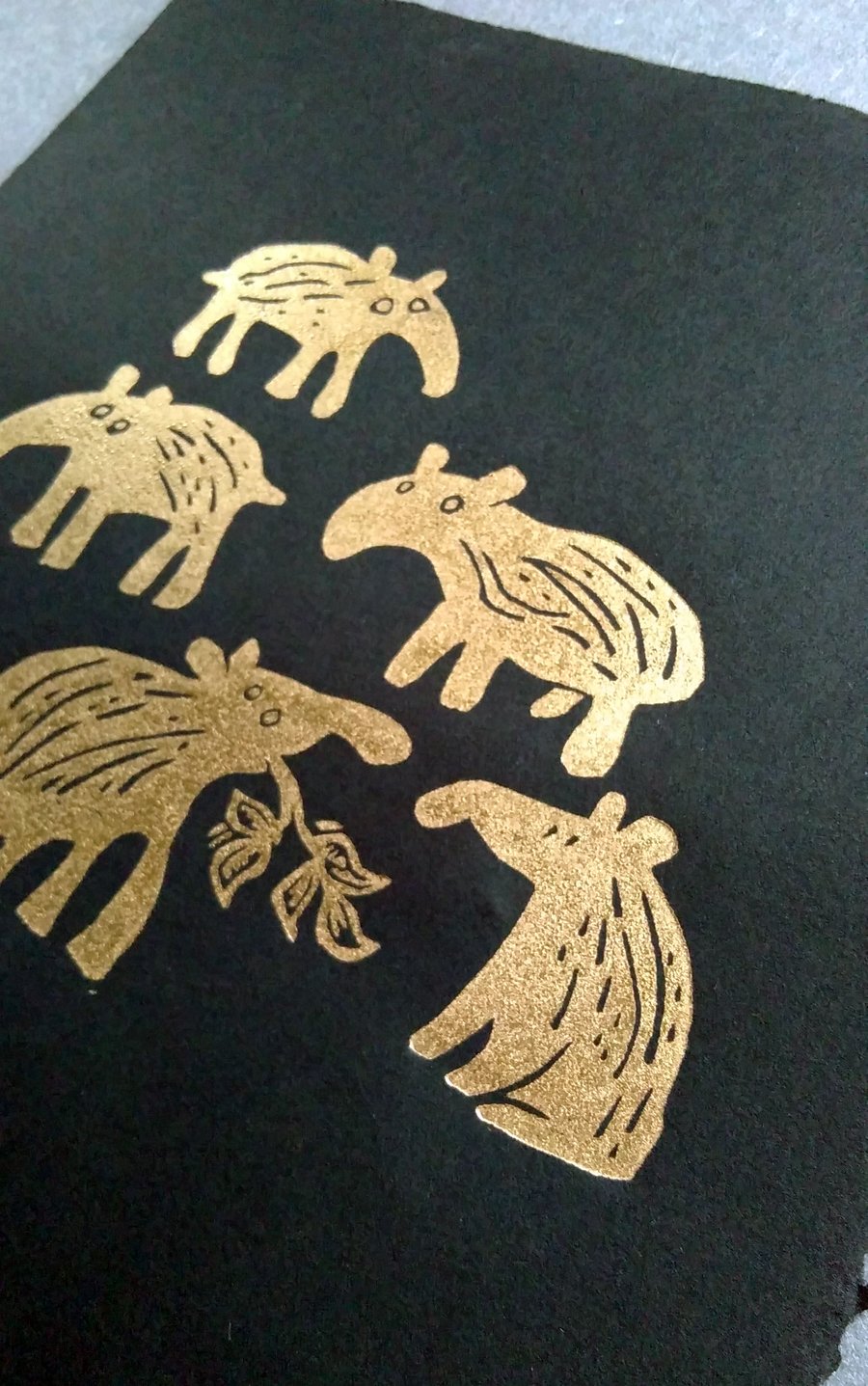 Five Gold Baby Tapirs - lino cut print